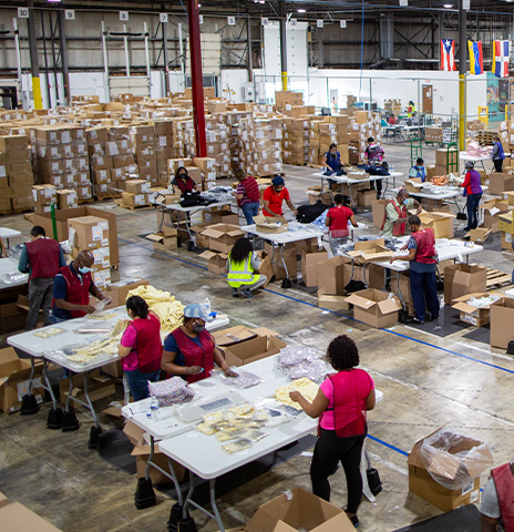Warehouse workers fulfilling projects on floor.