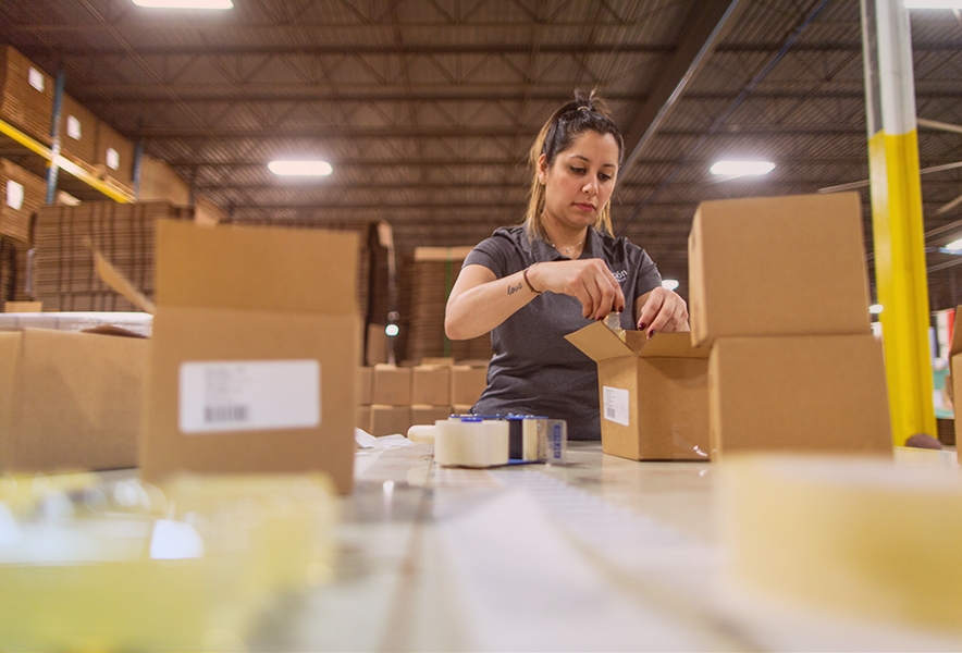 Warehouse worker providing Amazon Kitting Service for a client.
