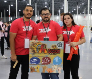 Group of three holding pallet sign designed for event.